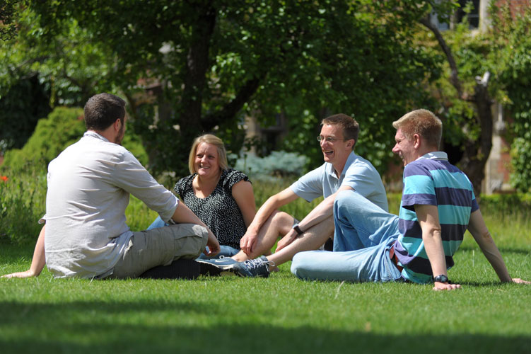 Students sitting in the grass